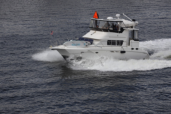 BOAT.WHITE HULL.SURFSTAR SURFBOARD IN FRONT.08