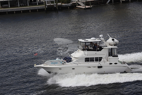 BOAT.WHITE HULL.SURFSTAR SURFBOARD IN FRONT.13