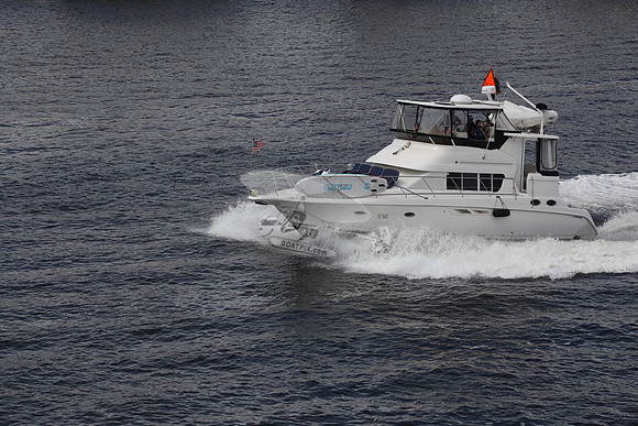 BOAT.WHITE HULL.SURFSTAR SURFBOARD IN FRONT.09