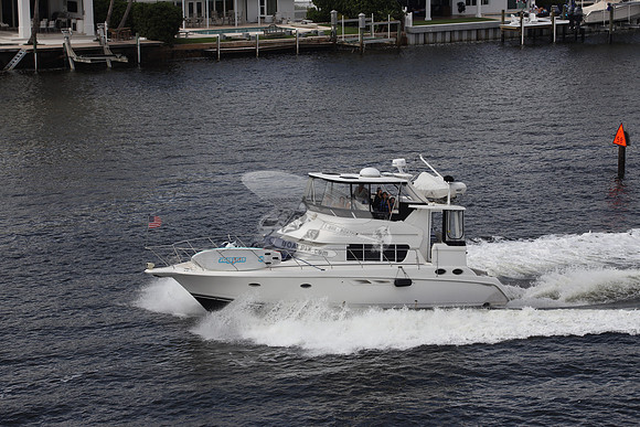 BOAT.WHITE HULL.SURFSTAR SURFBOARD IN FRONT.11