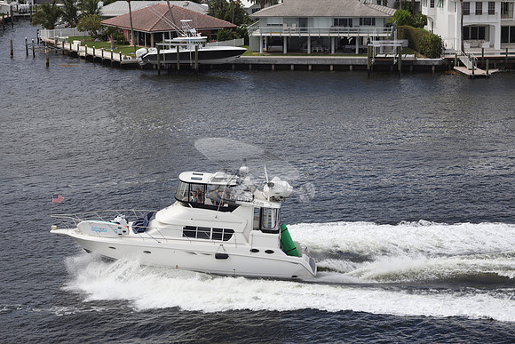 BOAT.WHITE HULL.SURFSTAR SURFBOARD IN FRONT.16