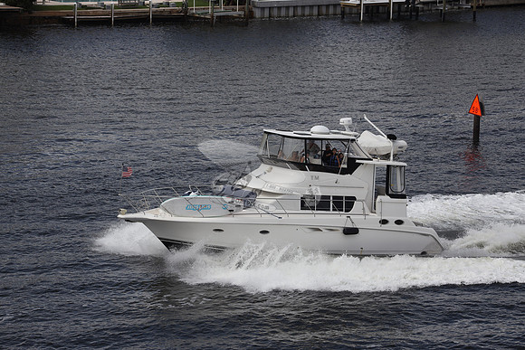 BOAT.WHITE HULL.SURFSTAR SURFBOARD IN FRONT.10